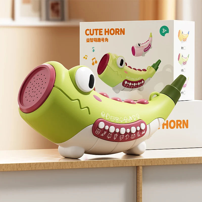 Toy horn with a box labeled 'Cute Horn' on a wooden surface.