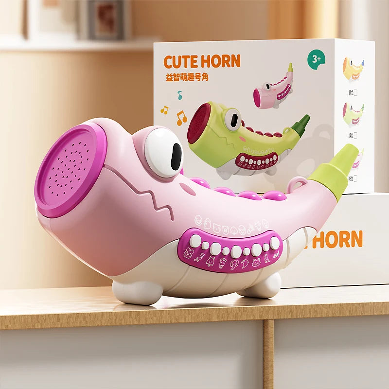 Pink and green toy horn with a box in the background