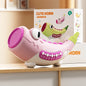 Pink and green toy horn with a box in the background